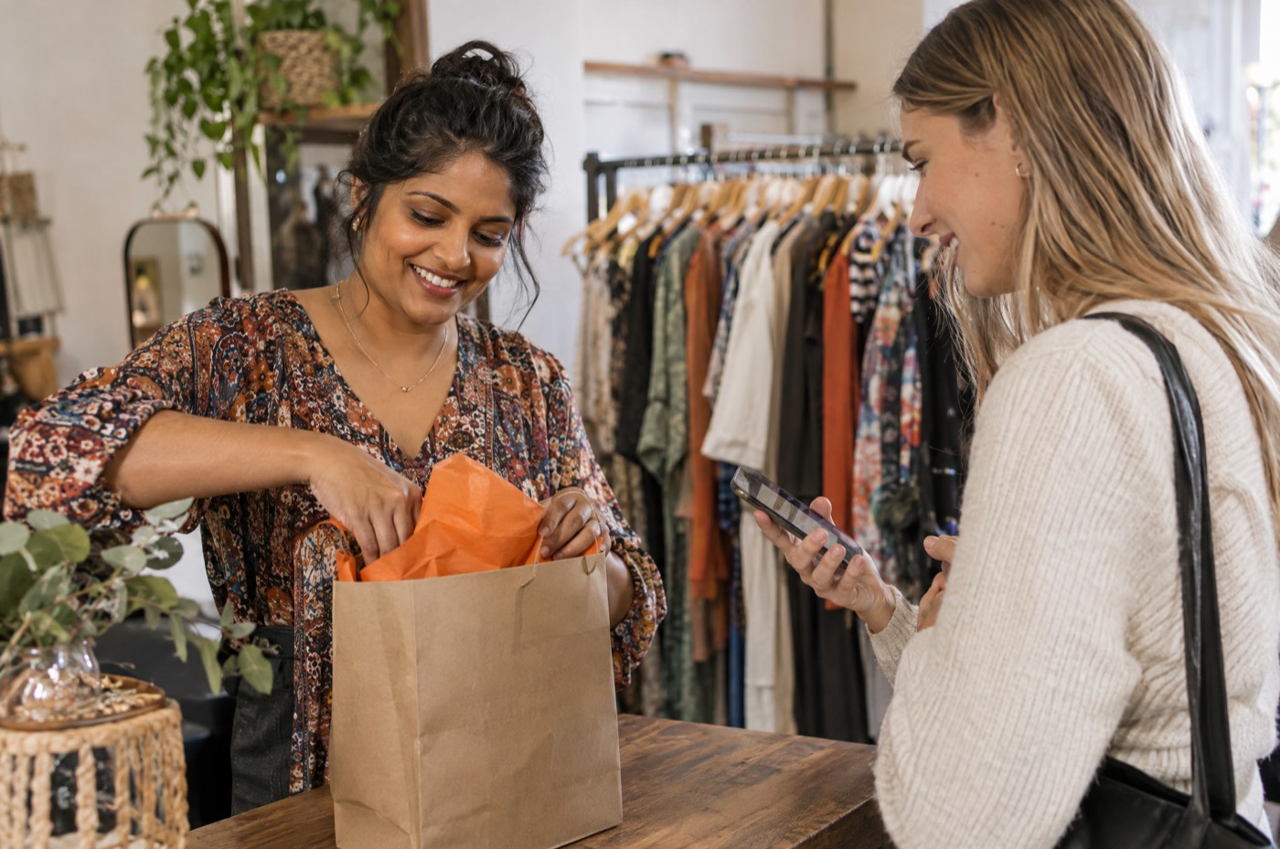 Boutique owner packing an order for a customer who found the shop online
